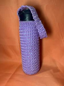Handmade purple crocheted water bottle sleeve with strap.