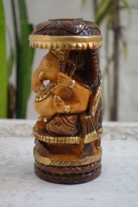 Hand Crafted Wooden Ganesha seated on his throne under a beautiful umbrella.