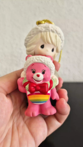 Precious Moments girl with a pink care bear in Christmas wreath hanging ornament