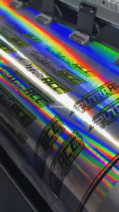 CETAK STIKER HOLOGRAM RAINBOW CUSTOM METERAN PRINT LAMINASI CUTTING INDOOR ECOSOLVENT STIKER SOUND Paper