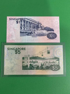 Singapore one dollar and five dollar banknotes with bird and cityscape designs.