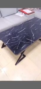 A minimalist and modern style steel-coated glass coffee table for the living room suitable for small apartment living rooms a simple and multi-functional central table in the living room applicable for the living area.