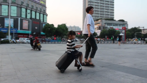 2-in-1 kids rolling suitcase with seat – a convenient travel bag for children also suitable as a carry-on bag for airline travel.