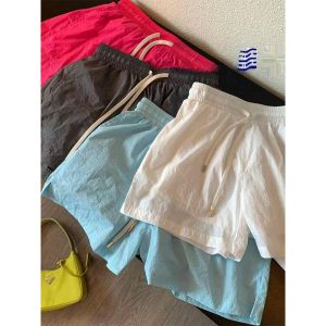 กางเกงขาสั้นผู้หญิงสีลูกกวาดแห้งเร็ว กางเกงขายาวทรงหลวม กางเกงขายาวลำลองสำหรับเล่นกีฬาในช่วงฤดูร้อน 2024 กางเกงขายาวทรงหลวมสำหรับใส่ไปทำงาน