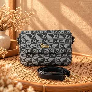 Brand: Boudia Main product: crossbody bag Key attributes: patterned design gold lettering adjustable strap multiple colors Fit/use: casual everyday use Scene: indoor setting with natural light