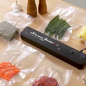 Máy Hút Chân Không Màu Đen 220V/110V Dùng Cho Đóng Gói Thực Phẩm Gia Đình Có Đế Điện Chiều Dài Hàn Kín 32cm Và Kèm Túi Hút Chân Không