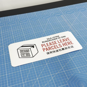 Please Leave Parcels Here. Sila Letak Bungkusan Di Sini 请将快递包裹放在这. Sticker Sign Notice Delivery Package Pos Parcel Drop
