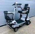 Electric mobility scooter with black seat and basket. 110cm length, 52cm width, 97cm height. Adjustable armrests and footrest.. 