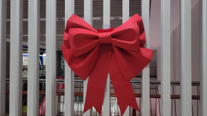 Giant Red Butterfly Bow for Party Decoration on Christmas Tree with Ornaments and Greenery