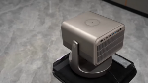 Hisense Vidda C2 Ultra 4K Projector with wireless charging stand compact design adjustable base modern metallic finish and advanced lens technology.