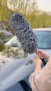 The retractable mop with soft bristles is safe for car paint and does not shed fibers