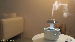 ร่มฝนพร้อมเครื่องทำความชื้นและกระจายกลิ่นหอม พร้อมเสียงฝนที่ผ่อนคลาย เอฟเฟกต์น้ำหยด ไฟสี 7สี ตั้งเวลาและปิดอัตโนมัติ เหมาะสำหรับการพักผ่อน นอนหลับ ที่บ้าน ห้องนอน โต๊ะทำงาน ความเร็ว3ระดับ รุ่นV88