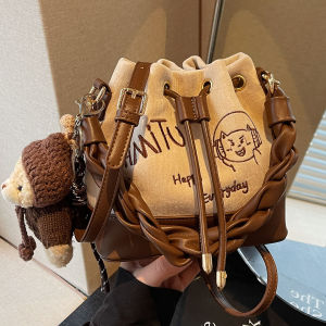 NALLCHEER Charming Bucket Bag with Cartoon Bear Charm Drawstring Closure and Twisted Handle for Everyday Fashion