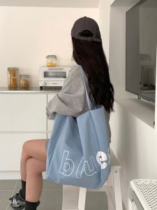 Classic Letter Pattern & Blue Canvas Shoulder Bag: A Stylish Commuter's Essential