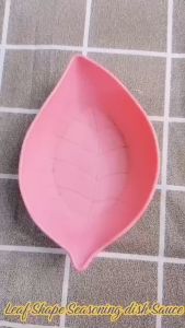 FLAVOUR DISH LEAF SHAPED SEASONING - HXAMH\\n\\n Introduction to Leaf Shaped Seasoning Plate\\n\\nIntroducing the HXAMH Seasoning Plate - a unique and chic addition to your kitchen table. Designed with environmental protection in mind, this seasoning plate is made of non-toxic, safe-to-use plastic, making it perfect for enhancing the flavor of your dishes.\\n\\n Product Overview\\n\\nThe HXAMH Seasoning Plate is a versatile kitchen accessory that can be used for seasonings, snacks, and more. With its leaf-shaped design, this seasoning plate adds a fresh touch to any table setting. Available in four colors - green, purple, pink, and beige - there's a color to match every taste and decor.\\n\\n Key Features\\n\\n- **Color:** Green, Purple, Pink, Beige\\n- **Material:** Plastic\\n- **Size:** 7*11cm\\n\\n How to Use HXAMH Seasoning Plate\\n\\n Proper Storage\\n\\nTo ensure the longevity of your HXAMH Seasoning Plate, store it in a cool, dry place away from direct sunlight. Avoid stacking heavy items on top of the plate to prevent damage.\\n\\n Cleaning Instructions\\n\\nCleaning your HXAMH Seasoning Plate is simple and easy. Just rinse the plate with water and dry it off with a clean cloth. For stubborn stains, use a mild detergent and a soft sponge.\\n\\n Benefits of Using HXAMH Seasoning Plate\\n\\n Unique Design\\n\\nThe leaf-shaped design of the HXAMH Seasoning Plate makes it stand out from other seasoning plates on the market. Its unique appearance will add a fresh touch to any table setting, making it perfect for special occasions or everyday use.\\n\\n Environmental Protection\\n\\nThe HXAMH Seasoning Plate is made of environmentally friendly plastic, making it a sustainable choice for your kitchen. Its non-toxic, safe-to-use material ensures that you can enjoy your favorite dishes without worrying about harmful chemicals.\\n\\n Versatility in Kitchen\\n\\nThe HXAMH Seasoning Plate is versatile enough to be used for a variety of purposes in the kitchen. Whether you're serving seasonings, snacks, or other small items, this seasoning plate is the perfect choice. Its compact size makes it easy to store and transport, making it a convenient addition to any kitchen.\\n\\nIn conclusion, the HXAMH Seasoning Plate is a must-have for any kitchen. Its unique design, environmental protection, and versatility make it a valuable addition to any table setting. Order yours today and experience the difference a HXAMH Seasoning Plate can make in your kitchen!\"