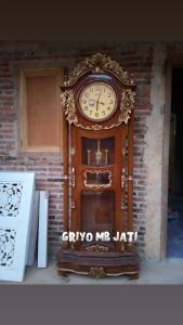 lemari jam hias lonceng ukir kayu jati