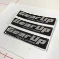 GEAR UP Logo Emblem Original Design Perodua Bezza Acia Myvi Ativa Alza Aruz Kancil Kelisa Kenali Kembara   Size: 7cm x 1.6cm  Ukuran: 70 x 16mm  Sticker 3M Original Design Perodua Emblem. 