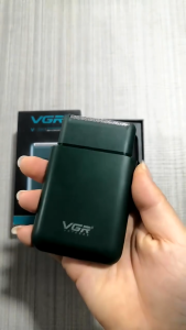 VGR 390 Shaver dark green compact electric grooming device with USB charging cable and cleaning brush.