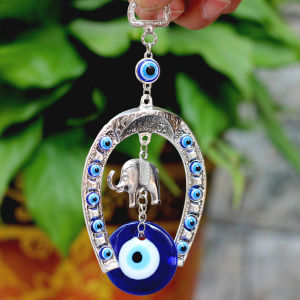 Silver elephant charm with blue evil eye beads decorative accessory for home and car.