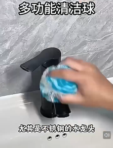 Blue and white round kitchen sponge with hanging loop for cleaning.
