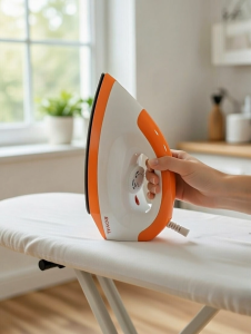 ROYAL DELUXE ELECTRIC DRY ORANGE IRON 1000W NON-STICK SOLE PLATE: EMPHASIZES ITS ELECTRIC NATURE AND 1000W POWER.