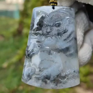 Very Unique Double Theme Natural Type A fine Jadeite pendant carved as Tiger [Front]  Landscape [Back]  with NGI Gemstone report weighs 30.33grams  54.29 * 37.61 * 5.73 mm  near colorless with patches of grey pendant for your daily wear (pendant158)