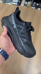 Black athletic sneakers with mesh upper and thick sole. Breathable design for running or casual wear.
