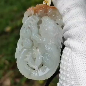 Carved with lizard bat peanut coin and ruyi Natural Type A Jadeite Pendant with NGI Gemstone report weight 136.84 grams 57.10 * 34.08 * 10.68 mm Translucent near colorless with reddish brown patch another good collection for collector (pendant132)