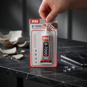 Hydro B-7000 Multi Adhesive Glue 40ml. Office desk scene with cracked teacup glasses smartphone and colorful gems.