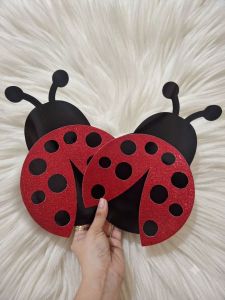 Glittered Ladybug Party Photo Prop - Black and red glittery ladybug cutouts with black spots and antennae. Suitable for festive party photo booth setups.