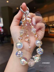 จี้ดอกไม้เล็ก โซ่ติดโทรศัพท์แบบสั้นสำหรับผู้หญิง เครื่องประดับระดับไฮเอนด์ ปลอกโทรศัพท์มือถือแบบป้องกันการสูญหาย โซ่โทรศัพท์มือถือเทรนด์ใหม่