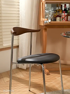 Elegant Modern Metal Frame Dining Chairs with Leather Upholstery in Black and Orange.