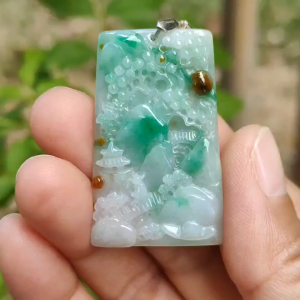 Good Quality Very Beautiful Light Green Brown Natural Type A Jadeite Jade crafted with sceneries as Pendant certificate weighs 9.72 grams measurement 40 * 24.8 * 4.6 mm (pendant288)