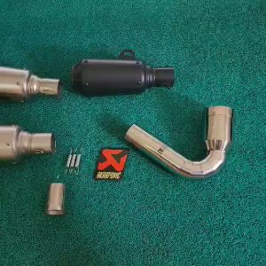 Akraphovic round canister with db reducer and a stainless elbow for a Dominar UG