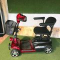 Electric mobility scooter with black seat and basket. 110cm length, 52cm width, 97cm height. Adjustable armrests and footrest.. 