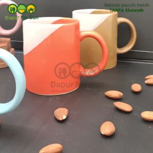 1 Pc Mug Gagang Two Tone 2 Warna Ukuran 300ml\r\n\r\n Deskripsi Produk & Spesifikasi\r\n\r\n Bahan & Kualitas\r\n\r\nMug Gagang Two Tone yang kami tawarkan ini terbuat dari stoneware berkualitas tinggi, yang memiliki kualitas di bawah porcelain. Stoneware adalah bahan yang kuat dan tahan lama, sehingga mug ini cocok digunakan sehari-hari. Merek yang diproduksi oleh Kaibon ini juga telah memenuhi standar SNI dan Food Grade, sehingga aman digunakan untuk minuman.\r\n\r\n Detail Ukuran & Kapasitas\r\n\r\nMug Gagang Two Tone memiliki ukuran diameter 8 cm dan tinggi 9,5 cm, dengan kapasitas 300 ml. Ukuran mug ini cukup ideal untuk menampung secangkir kopi atau teh favorit Anda. Selain itu, mug ini juga memiliki gagang yang memudahkan Anda saat mengambilnya.\r\n\r\n Sertifikasi & Keamanan\r\n\r\nMug Gagang Two Tone telah mendapatkan sertifikasi SNI dan Food Grade, sehingga aman digunakan untuk minuman. Anda tidak perlu khawatir tentang bahan kimia berbahaya yang mungkin terkandung dalam mug ini.\r\n\r\n Cara Penggunaan & Perawatan\r\n\r\n Tips Menggunakan Mug Two Tone\r\n\r\nUntuk memaksimalkan penggunaan Mug Gagang Two Tone, berikut beberapa tips yang bisa Anda lakukan:\r\n\r\n- Gunakan mug ini untuk menampung minuman panas atau dingin, tergantung selera Anda.\r\n- Jangan gunakan mug ini untuk menyimpan makanan, karena mug ini dirancang khusus untuk minuman.\r\n- Jangan gunakan mug ini di microwave, karena mug ini tidak tahan terhadap panas tinggi.\r\n\r\n Cara Membersihkan & Merawat Mug\r\n\r\nAgar Mug Gagang Two Tone tetap awet dan tahan lama, berikut beberapa cara membersihkan dan merawat mug:\r\n\r\n- Cuci mug menggunakan air hangat dan deterjen yang aman untuk piring dan gelas.\r\n- Jangan gunakan sikat keras saat membersihkan mug, karena bisa merusak permukaan mug.\r\n- Setelah dicuci, pastikan mug kering sebelum disimpan.\r\n\r\n Keunggulan & Manfaat\r\n\r\n Desain Unik & Cocok untuk Kerahasiaan\r\n\r\nMug Gagang Two Tone memiliki desain unik dengan dua warna yang menarik perhatian. Desain mug ini cocok untuk kerahasiaan, karena tidak mudah terlihat dari luar. Anda bisa menyimpan mug ini di meja kerja atau meja makan tanpa khawatir mengganggu estetika ruangan.\r\n\r\n Cocok untuk Kehidupan Sehari-hari\r\n\r\nMug Gagang Two Tone cocok digunakan sehari-hari, baik di rumah maupun di kantor. Mug ini memiliki ukuran yang ideal untuk menampung secangkir kopi atau teh favorit Anda. Selain itu, mug ini juga mudah dibersihkan dan tahan lama, sehingga bisa digunakan dalam jangka waktu yang lama.