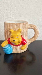 Winnie the Pooh stuck in a tree trunk ceramic mug