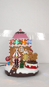 ONELINE #FC621 festive Luminal Park Christmas Village decoration features a handcrafted polyresin gingerbread house with a Moving Figurine and holiday music