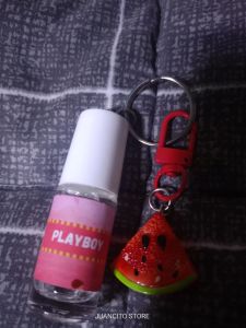 Mini anney perfume 5 ml with keychain lucky charm. Pink floral design. Keychain includes flower and charm.
