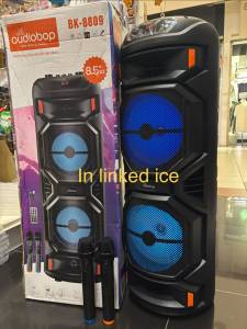 Portable multimedia speaker with wireless microphone support Bluetooth USB AUX. Super bass feature. Black color. Blue LED lights. Control knobs on top.