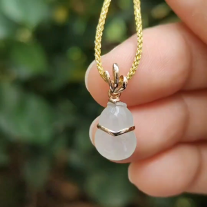 High Quality SG New Arrival crafted as small Gourd on Natural Type A Jadeite Jade set with 18k gold as pendant certificate weighs 1.01 grams measurement 18.9 * 8.3 * 4.3 mm (18kp75)