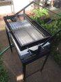 ROTATING BARBEQUE GRILL W/ FOLDABLE STAND. 