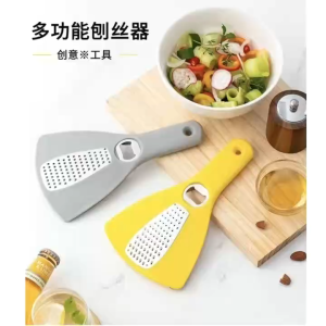 Multifunctional Vegetable Grater with Bottle Opener and Cutting Board | Gray and yellow grater tools with integrated bottle opener and cutting board. Ideal for preparing salads and garnishes.