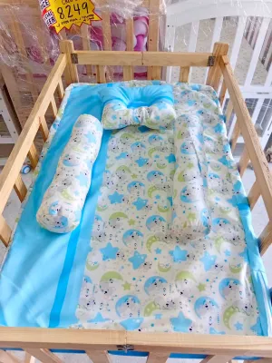 Varnish Adjustable Crib with Uratex Foam and Pillow Set (22x36 inches) - Wooden crib with adjustable height featuring colorful dinosaur-themed bedding and pillows.