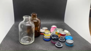 ขวด 50 มล. (50ใบ) ใส สีชา แก้วกลม + จุกเทา + ฝาflip off#20มม.(รูปภาพฝายังไม่ถูกปิดล็อค)