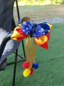 Colorful fabric hair bows with ribbons and pom-poms for kids.