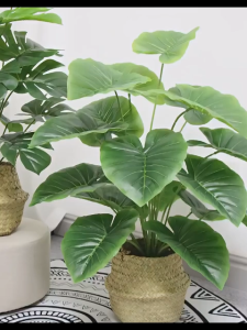 Potted artificial plants with vibrant green leaves crafted from durable plastic add a touch of nature to any space without maintenance needs