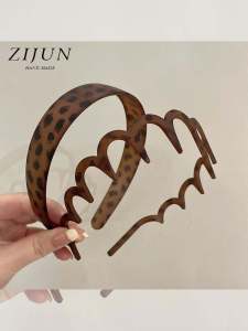 ริบบิ้นหนีบผมลายเสือดาวสไตล์ย้อนยุคแบบมีฟันสำหรับผู้หญิง หน้ากากล้างหน้าแบบมีฟัน ริบบิ้นหนีบผมแบบเรียบง่ายสไตล์เกาหลี