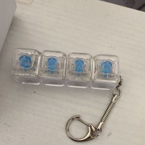 Meade | Fidget Clicker Keychain Transparent RGB 4-Button Tactile Feedback Pad Fun Stress Relief Mini Light-Up Gadget Desk Accessory Gift