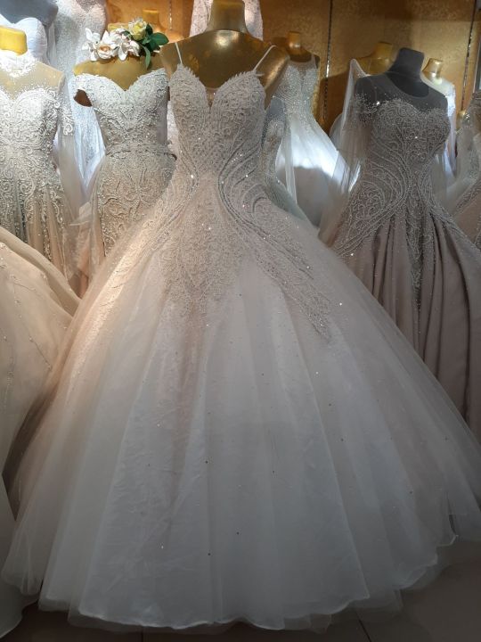 An elegant wedding gowns of different styles and sizes but of same  Prices vary depending on beads and lace Available in sizes